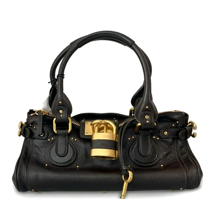 Black vintage handbag with gold accents on a white background
